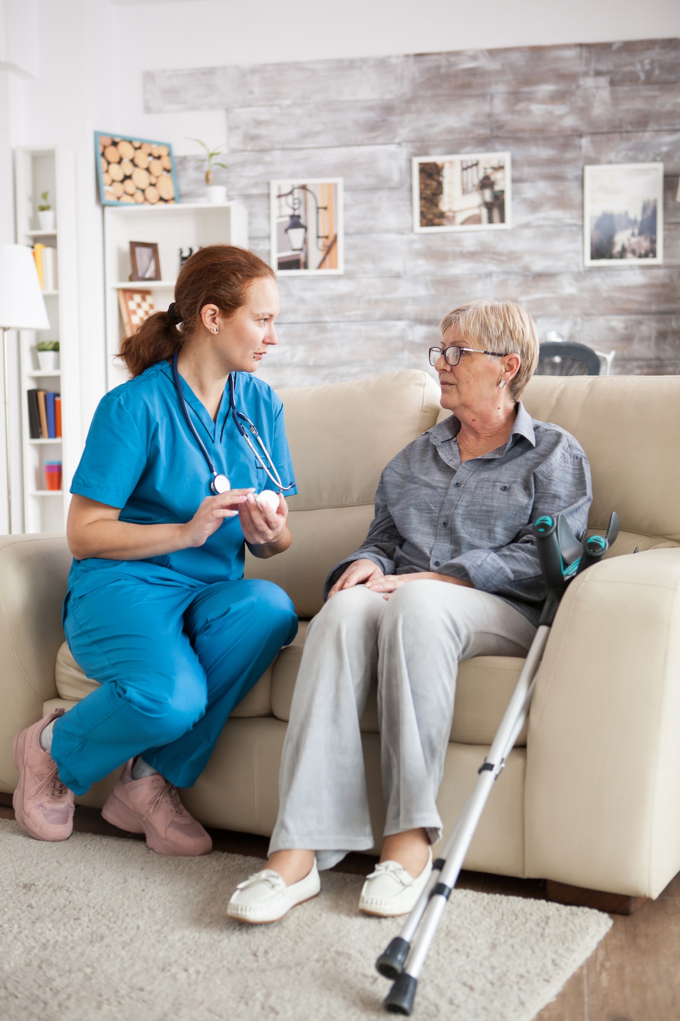 female-nurse-sitting-on-couch-with-senior-woman-3.jpg